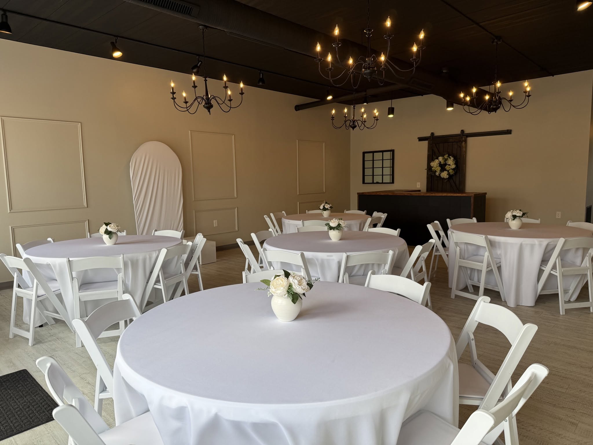 Warm chandelier lighting inside The Gathering Olean